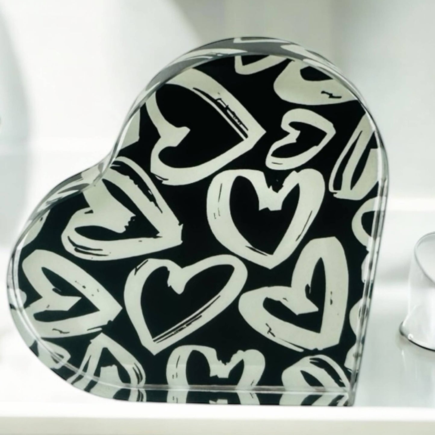 Heart-shaped object with black and white heart pattern on a white background