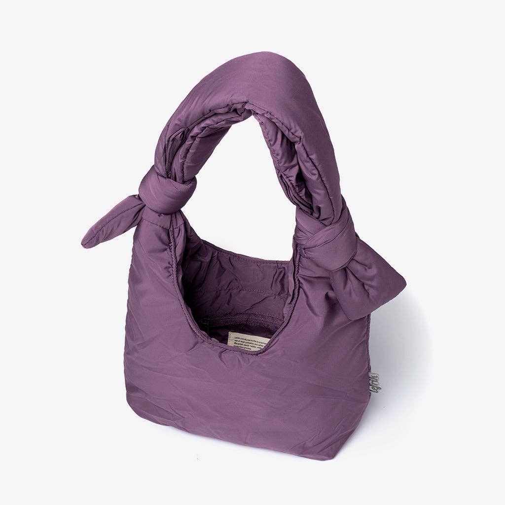 Purple bag with a bow on a white background