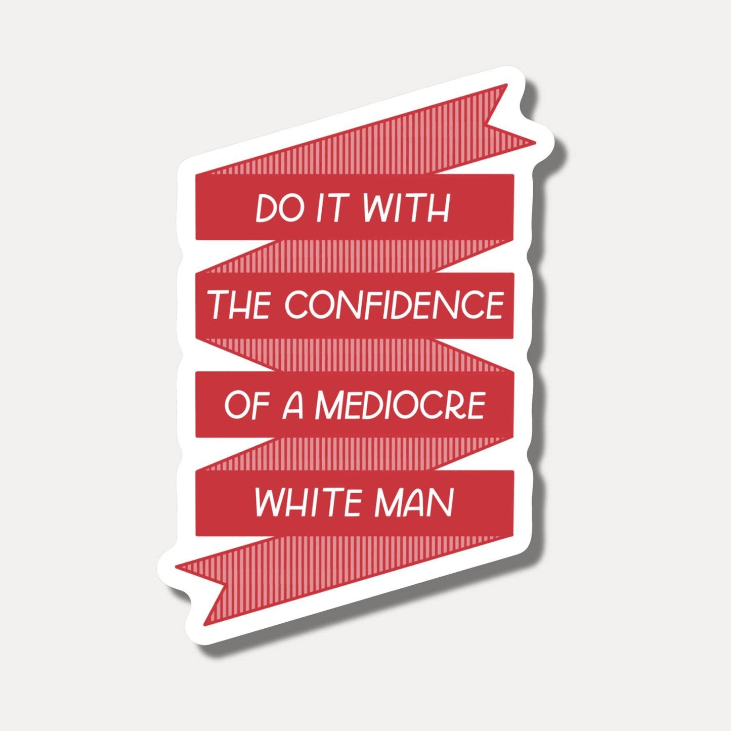 Red and white motivational quote sticker on a light gray background