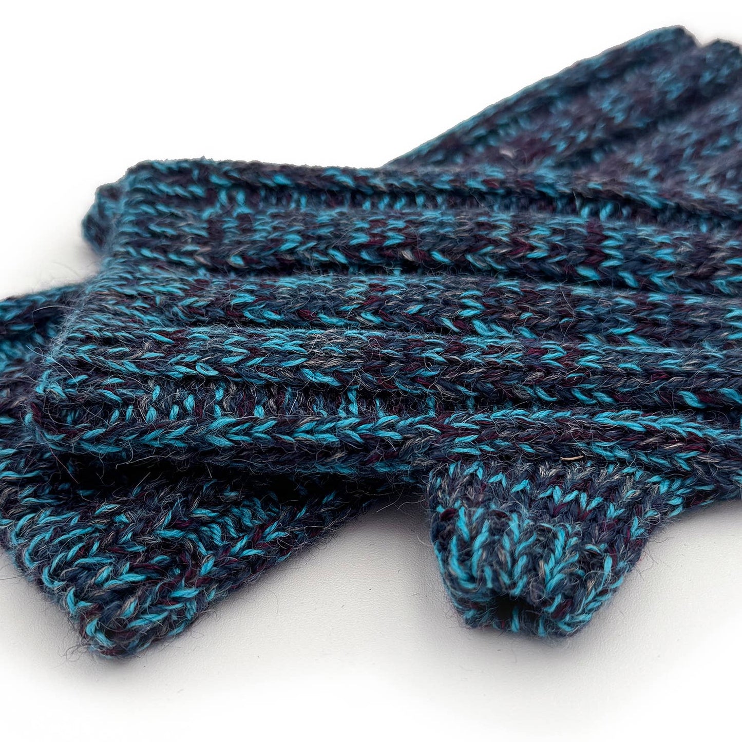 Pair of blue and purple knitted gloves on a white background