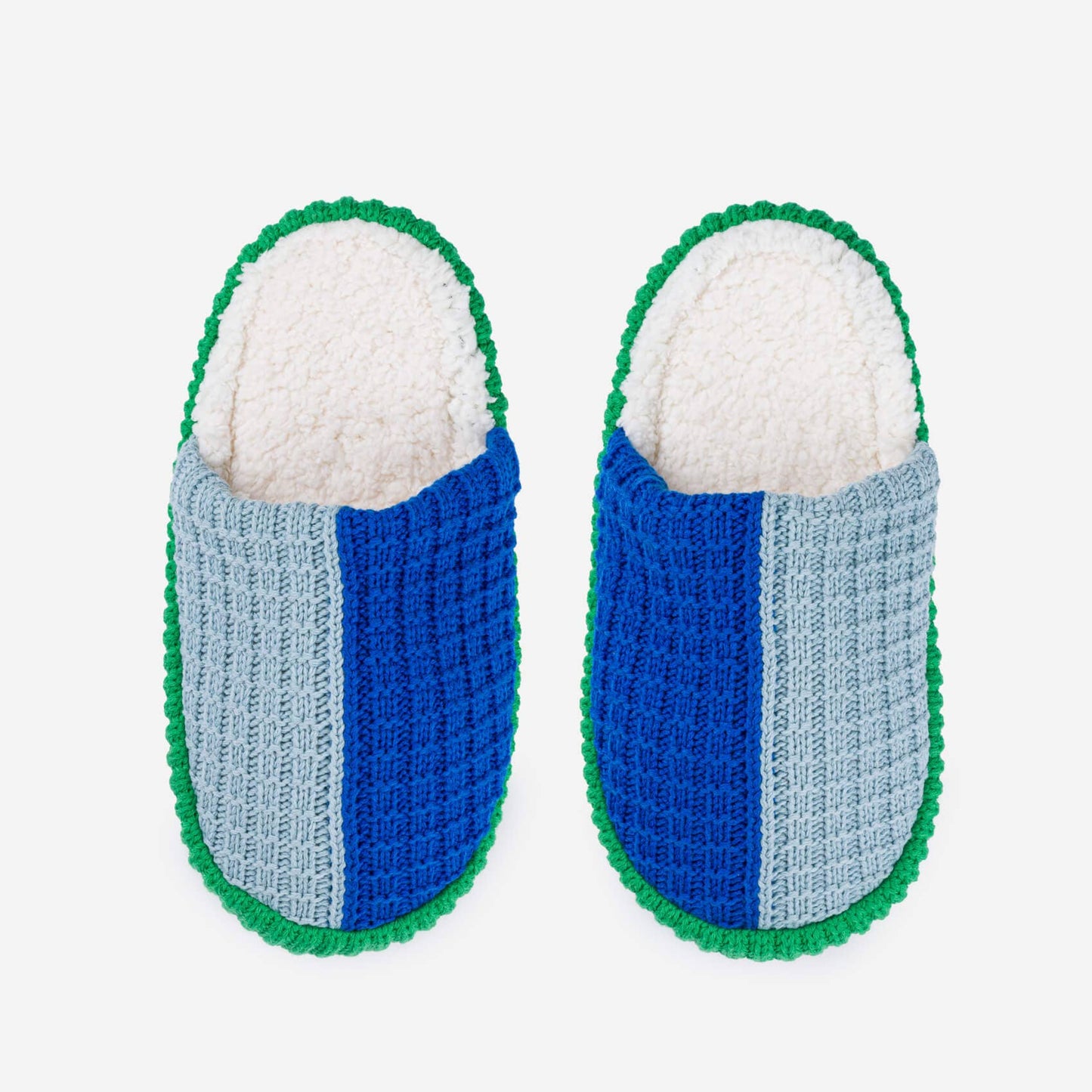 Pair of blue and gray slippers with green trim on a white background