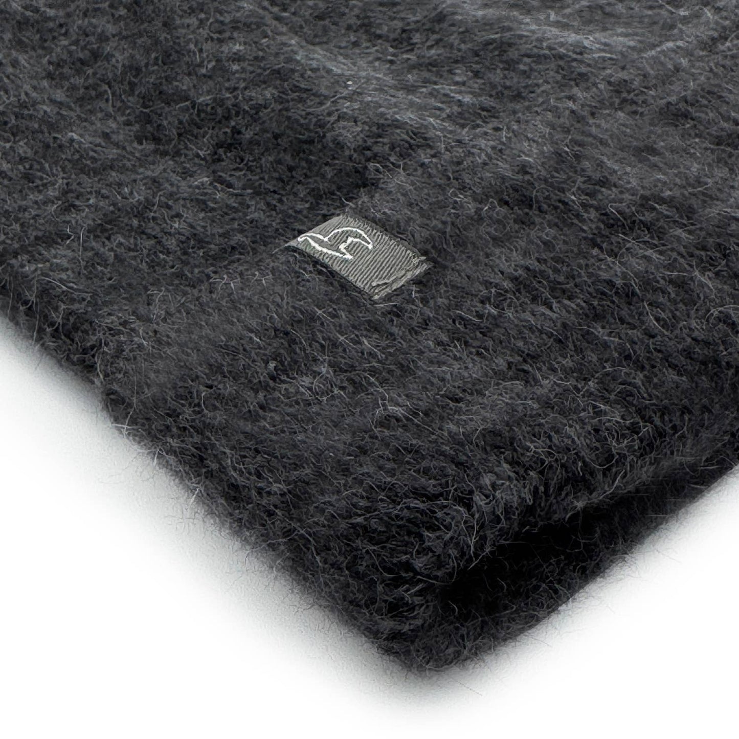 Dark gray knit fabric with a brand logo on a white background