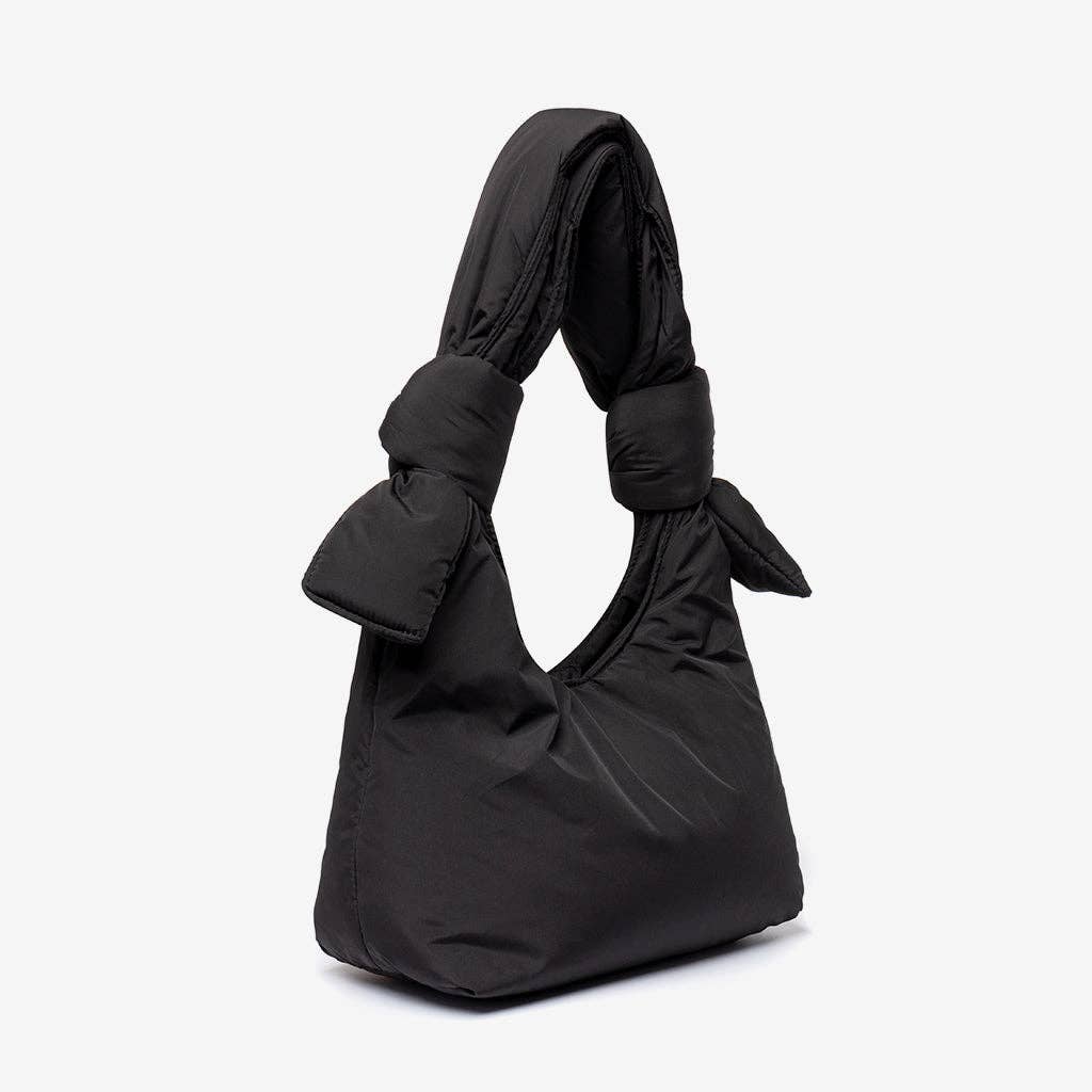 Black handbag with a knot detail on a white background