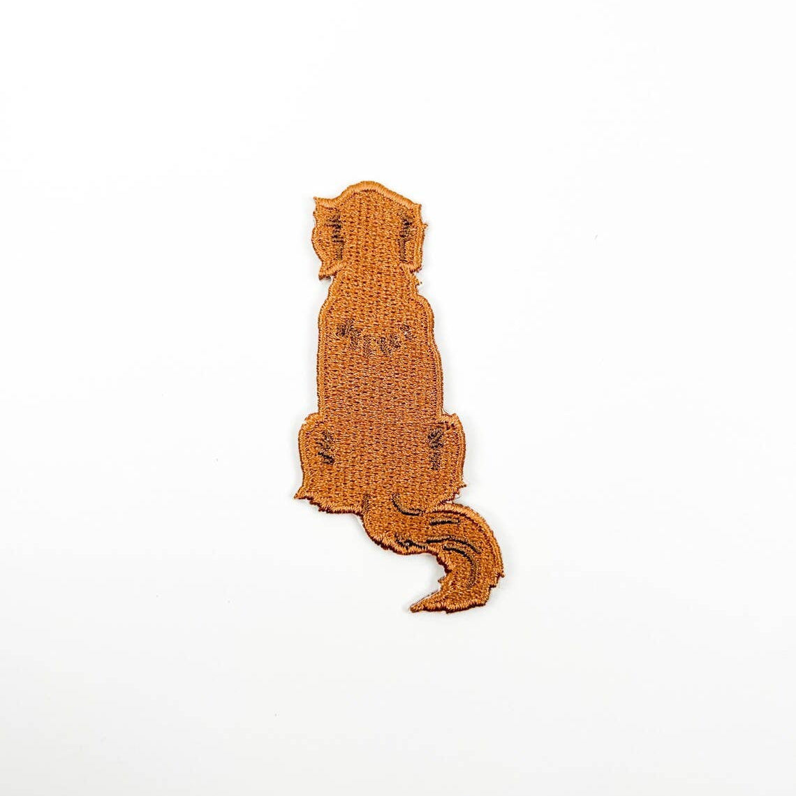 Brown patch with dog silhouette on a white background