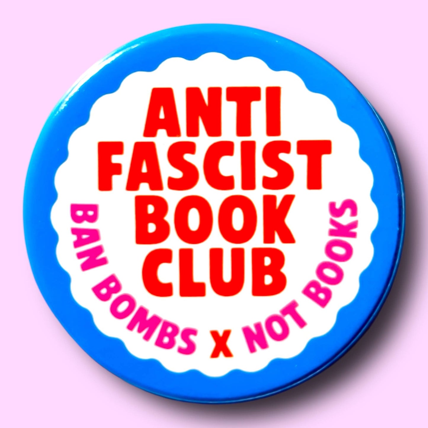 Button badge with 'Anti-Fascist Book Club' text on a pink background