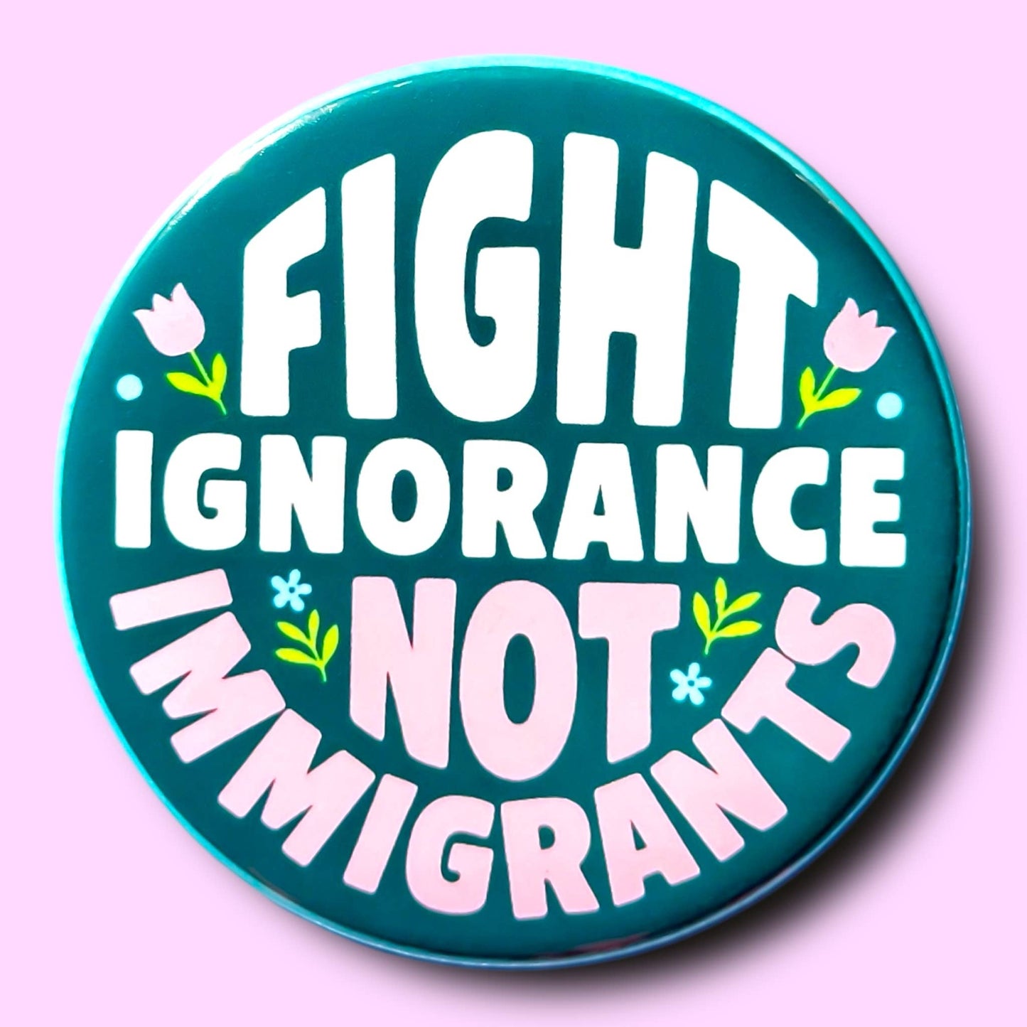 Button with 'Fight Ignorance Not Immigrants' text on a pink background