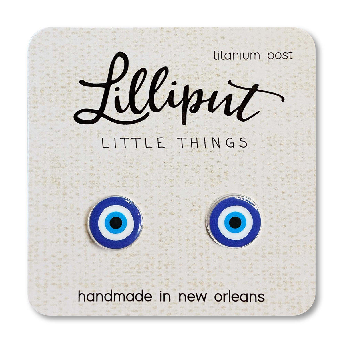 Pair of blue evil eye earrings on a 'Lilliput Little Things' branded card.