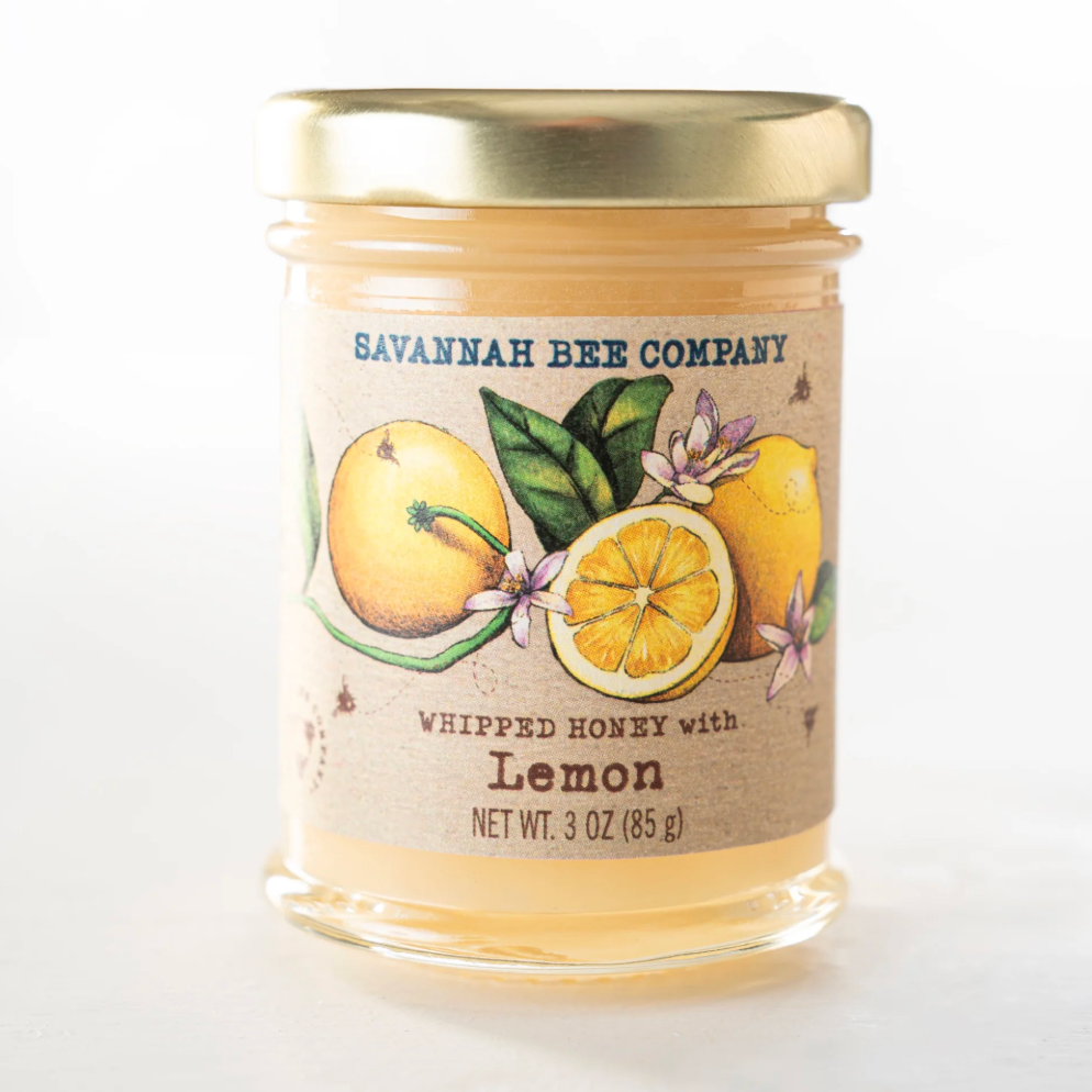 Jar of Savannah Bee Company whipped honey with lemon on a white background