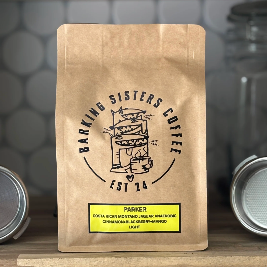 Barking Sisters Coffee package with branding and product details on a wooden surface.