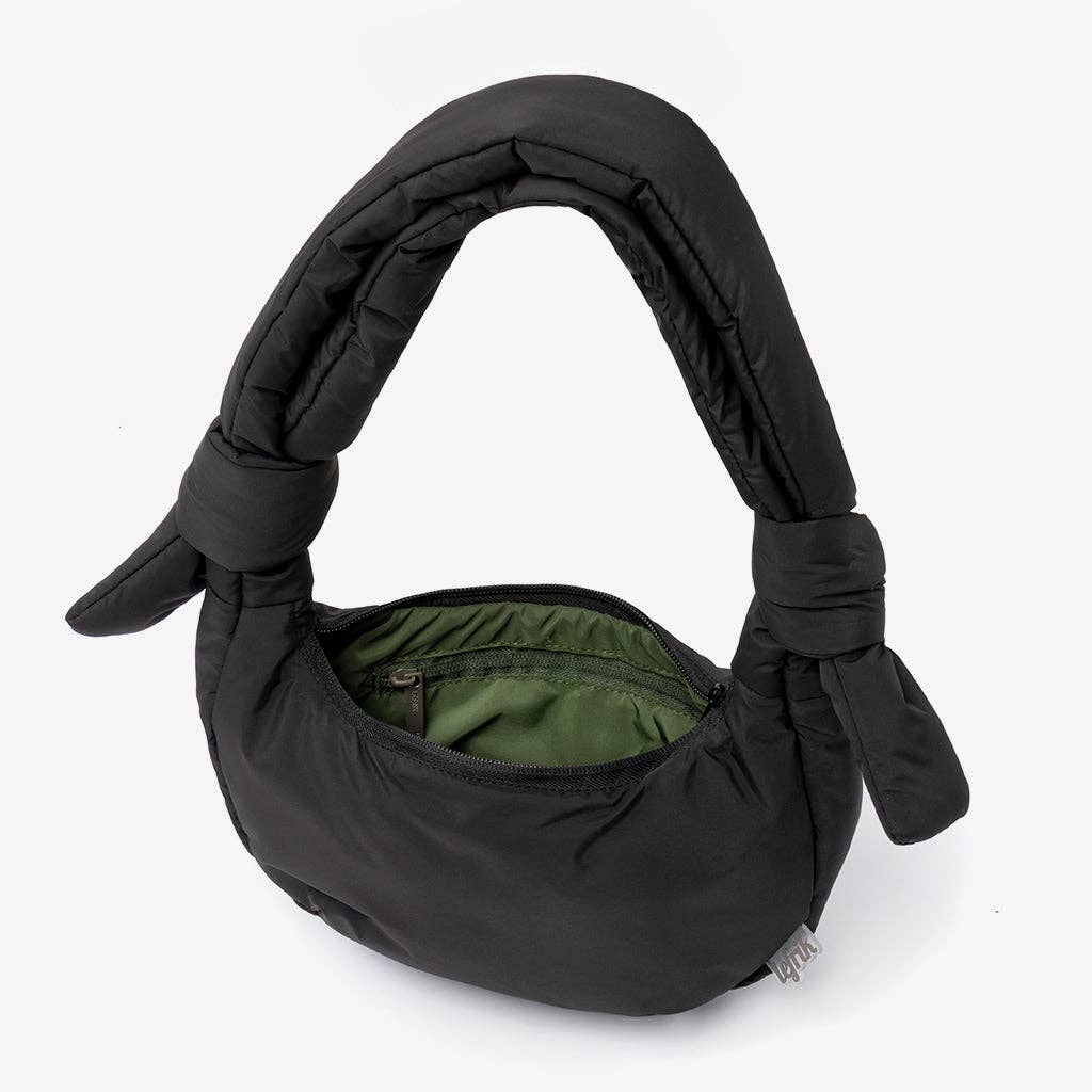 Black baby carrier with green interior on a white background