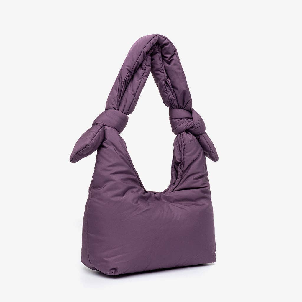 Purple handbag with knotted handle on a white background