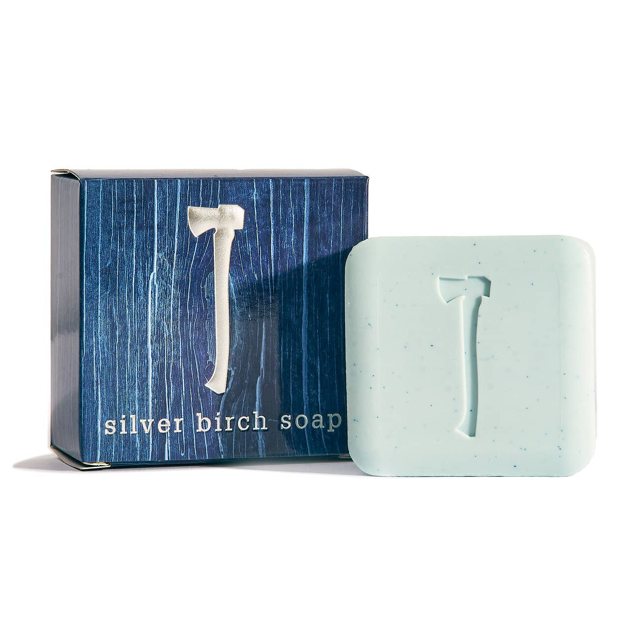 Bar of silver birch soap next to its packaging on a white background