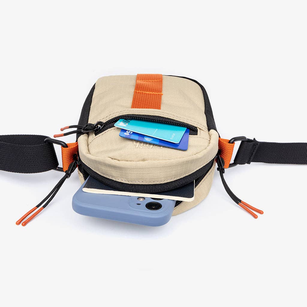 Beige waist bag with orange accents on a white background