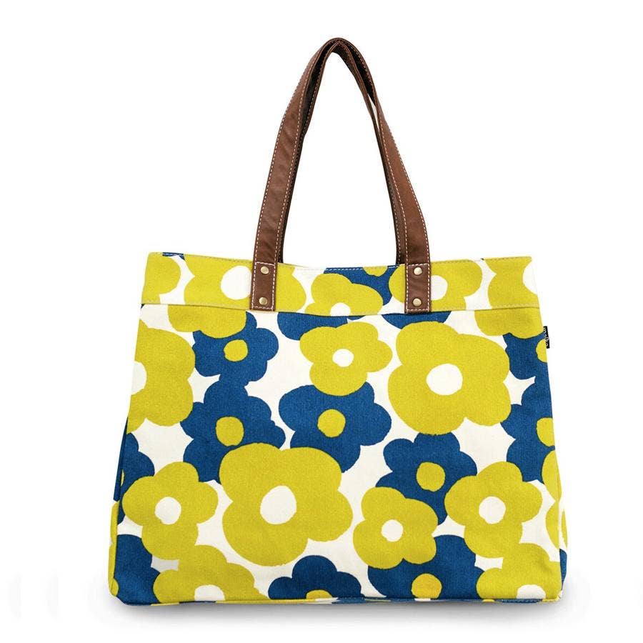 Floral patterned tote bag with brown handles on a white background
