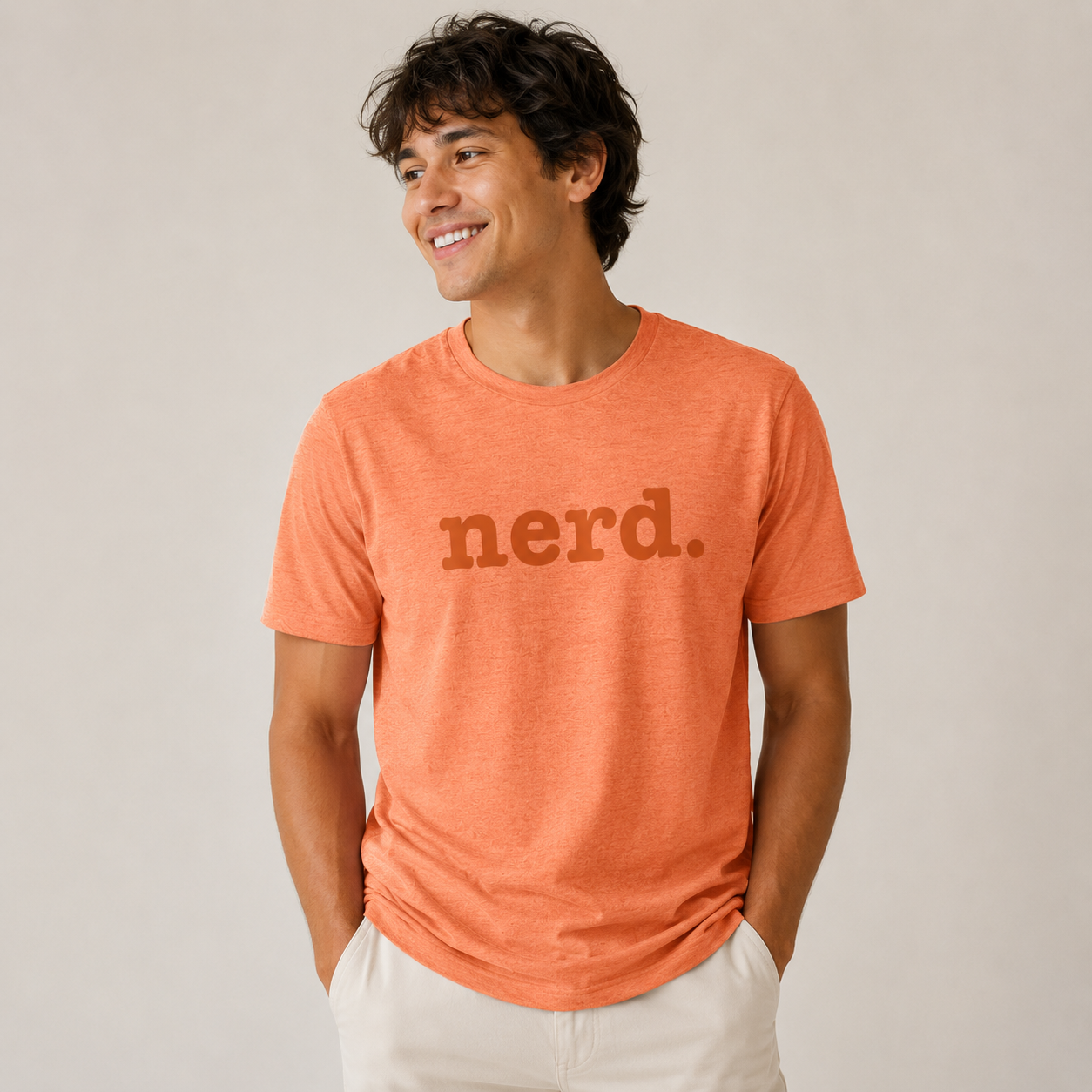 Man wearing an orange t-shirt with 'nerd.' text on a plain background