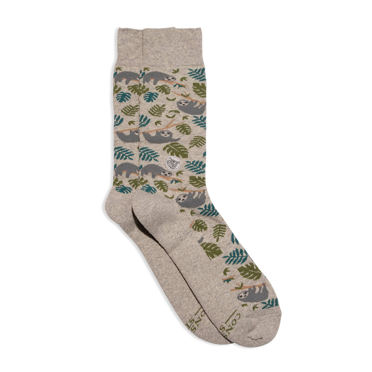 A pair of crew socks with a beige heather base, featuring a pattern of sloths and tropical leaves in green, teal, and gray. The brand name 'Sloth & Co.