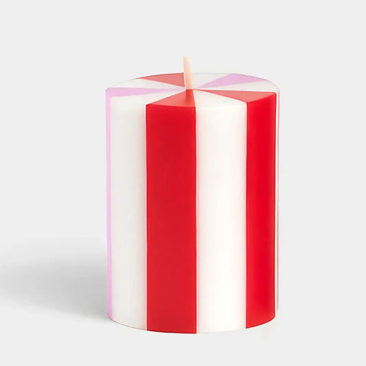 Red and white striped candle on a light gray background