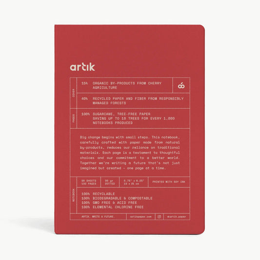 Red notebook with 'artik' branding and text on a white background