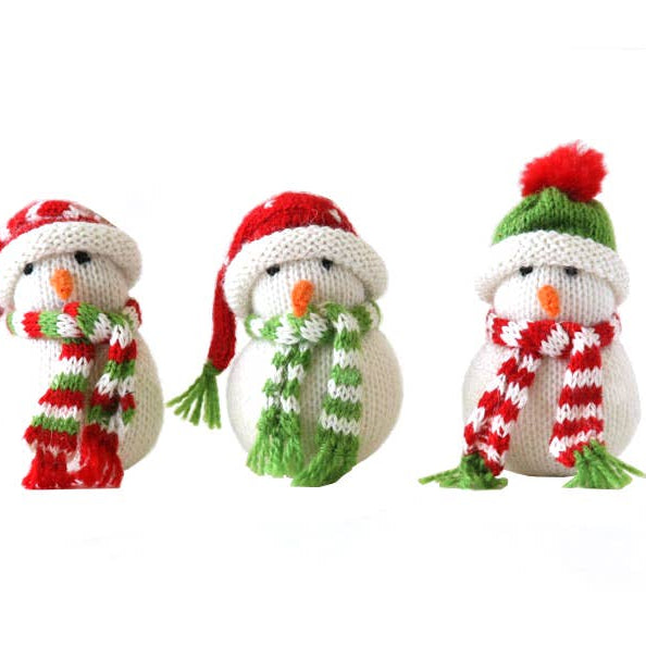 Three knitted snowmen with colorful hats and scarves on a white background