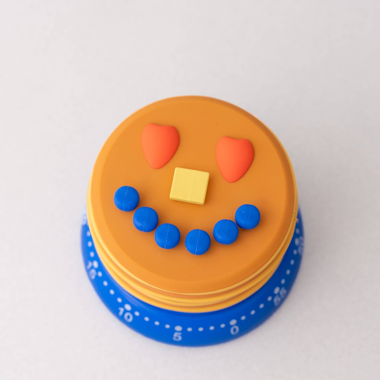 Small round cake with a smiley face on a white background