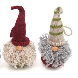 Three knitted gnomes with colorful hats on a white background