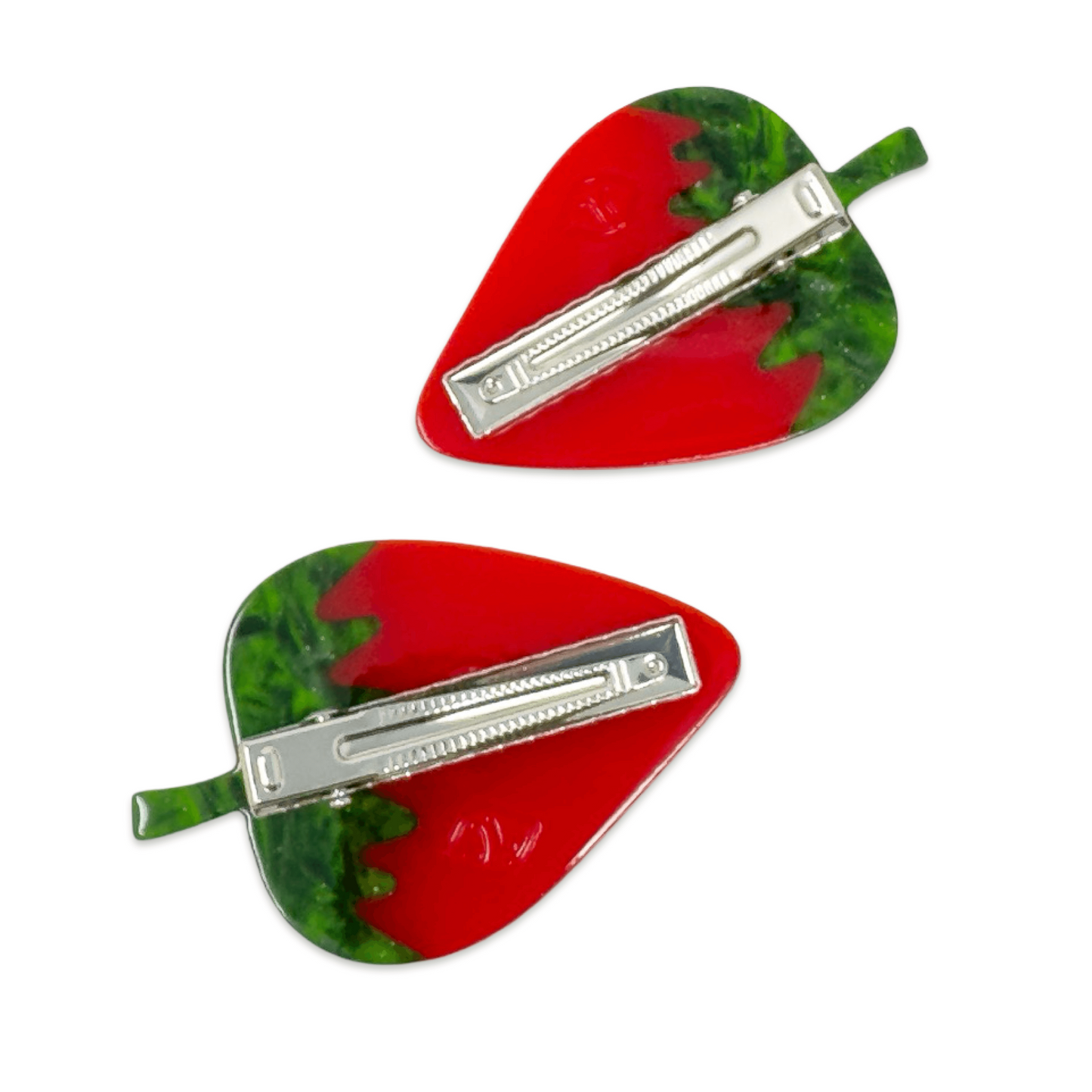 Two red and green hair clips with silver bars on a white background