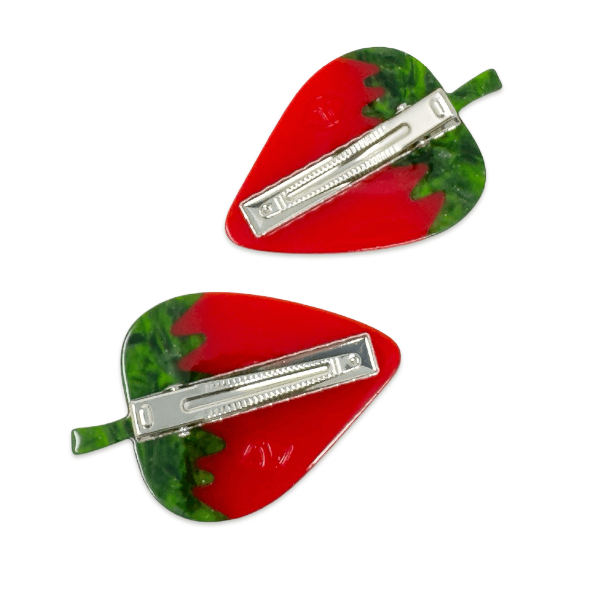 Two red and green hair clips with silver bars on a white background
