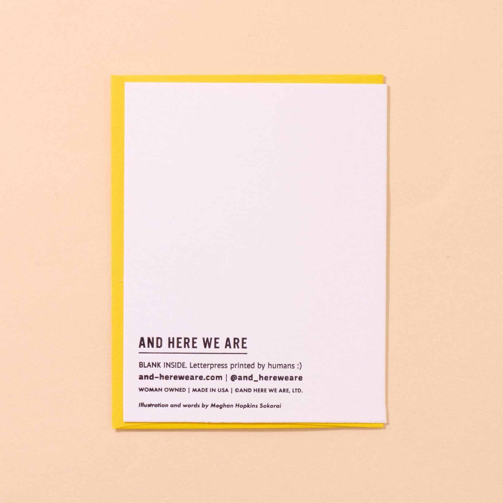 Letterpress card with yellow border and text on a beige background