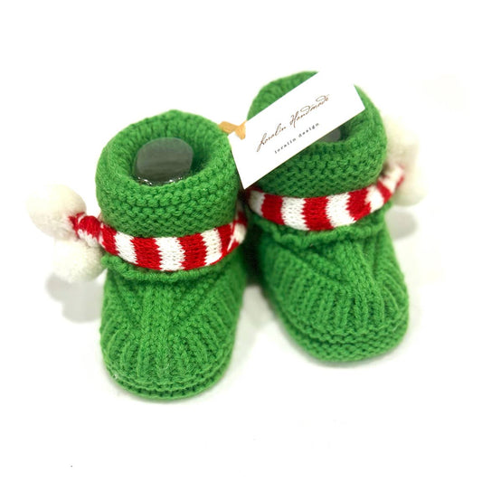 Green knitted dog boots with a red and white striped band on a white background