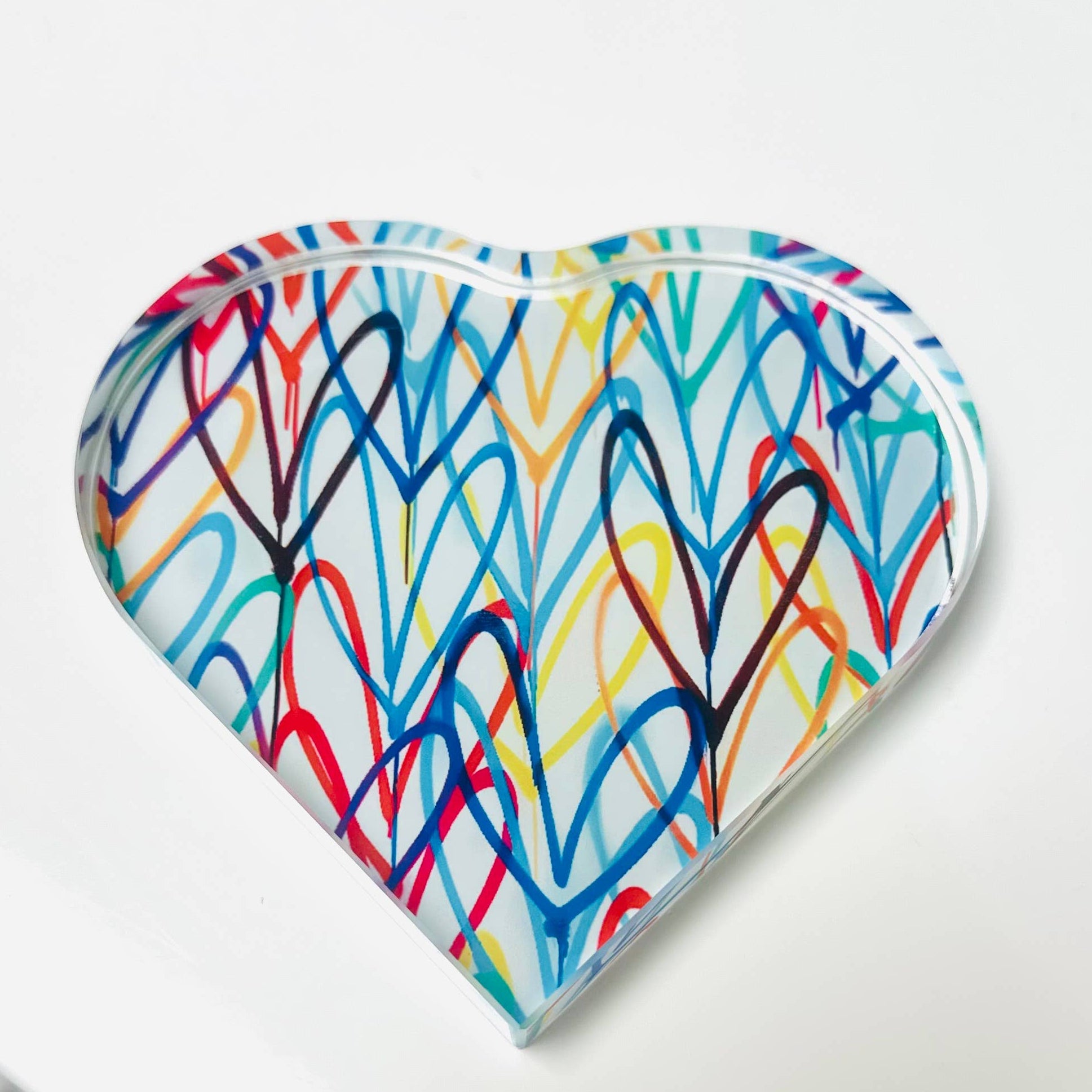 Heart-shaped object with colorful abstract pattern on a white background