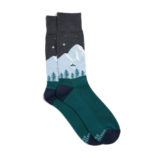 Pair of socks with mountain and tree design on a white background