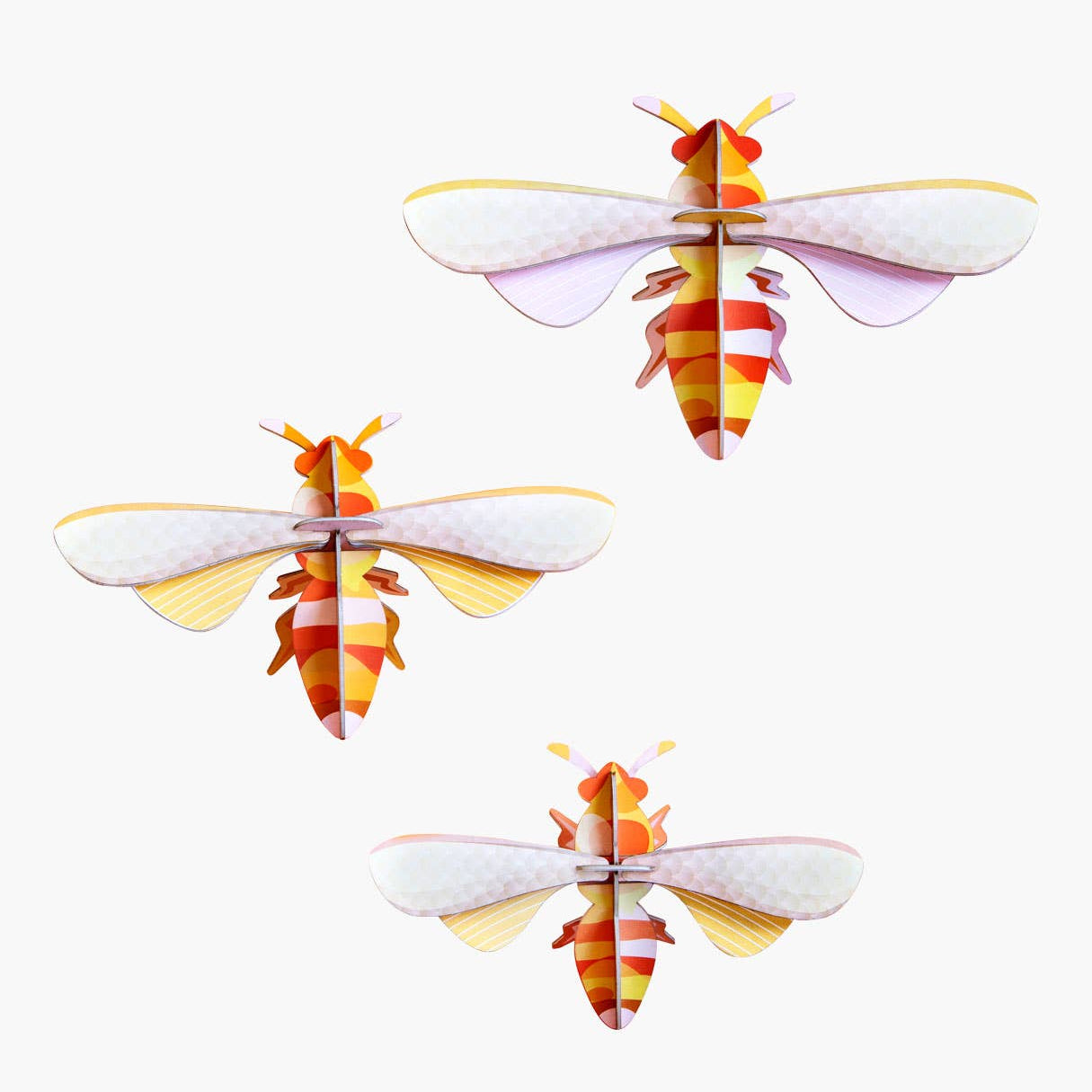 Four paper models of bees on a white background