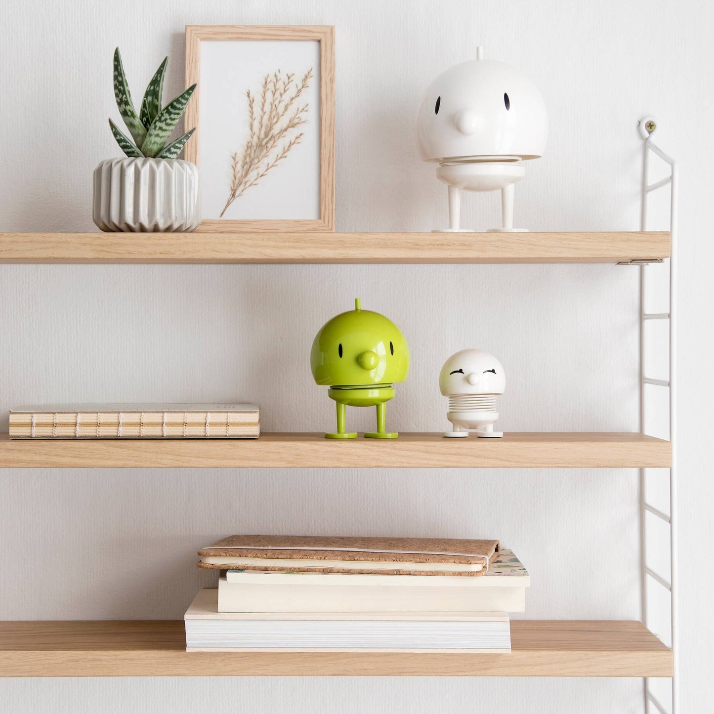 Wooden shelves with decorative items against a white wall