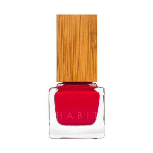 Red nail polish with a bamboo cap on a white background