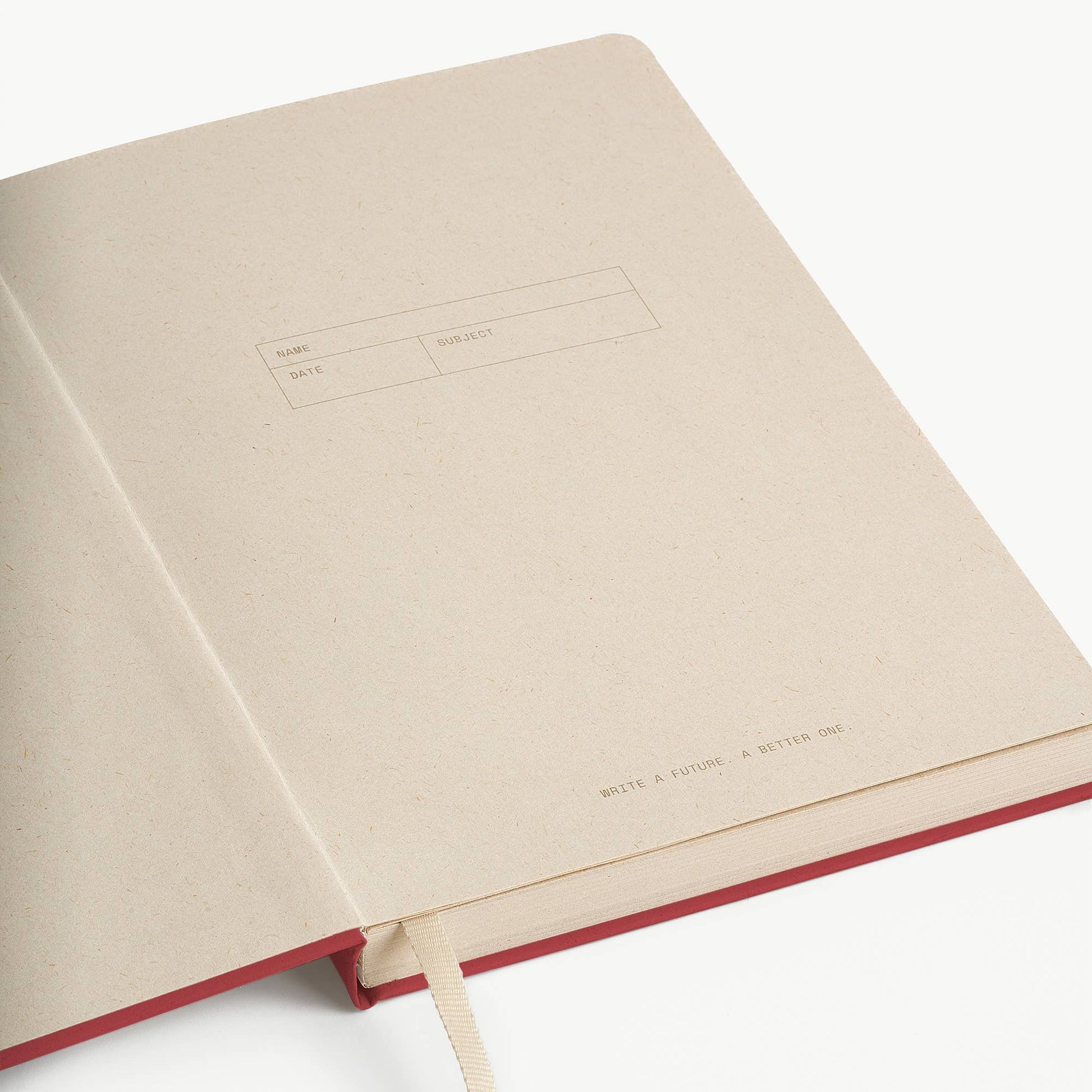 Open notebook with a red binding on a white background