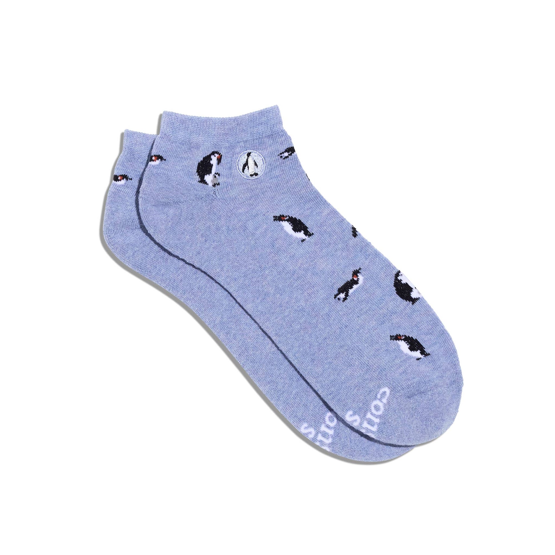 Pair of light blue socks with penguin pattern on a white background