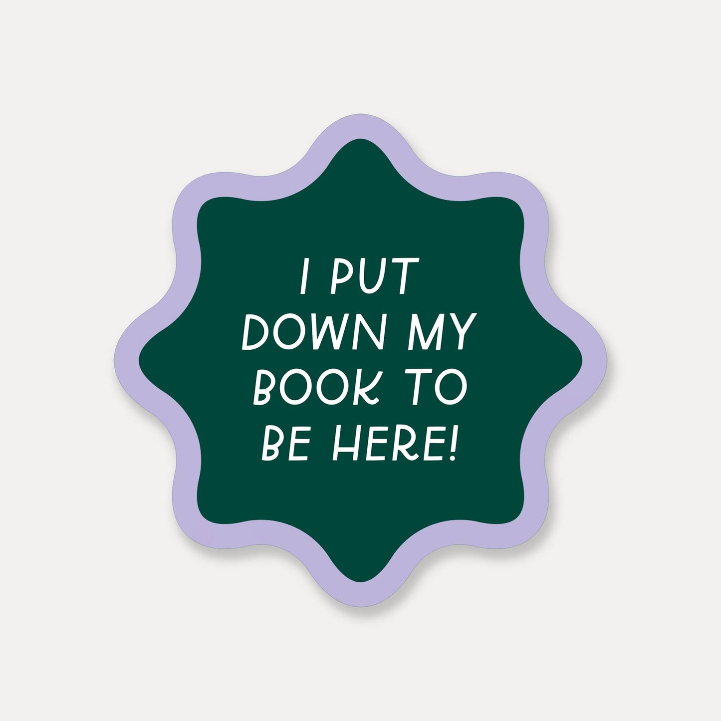 Green star-shaped sticker with white text on a light gray background