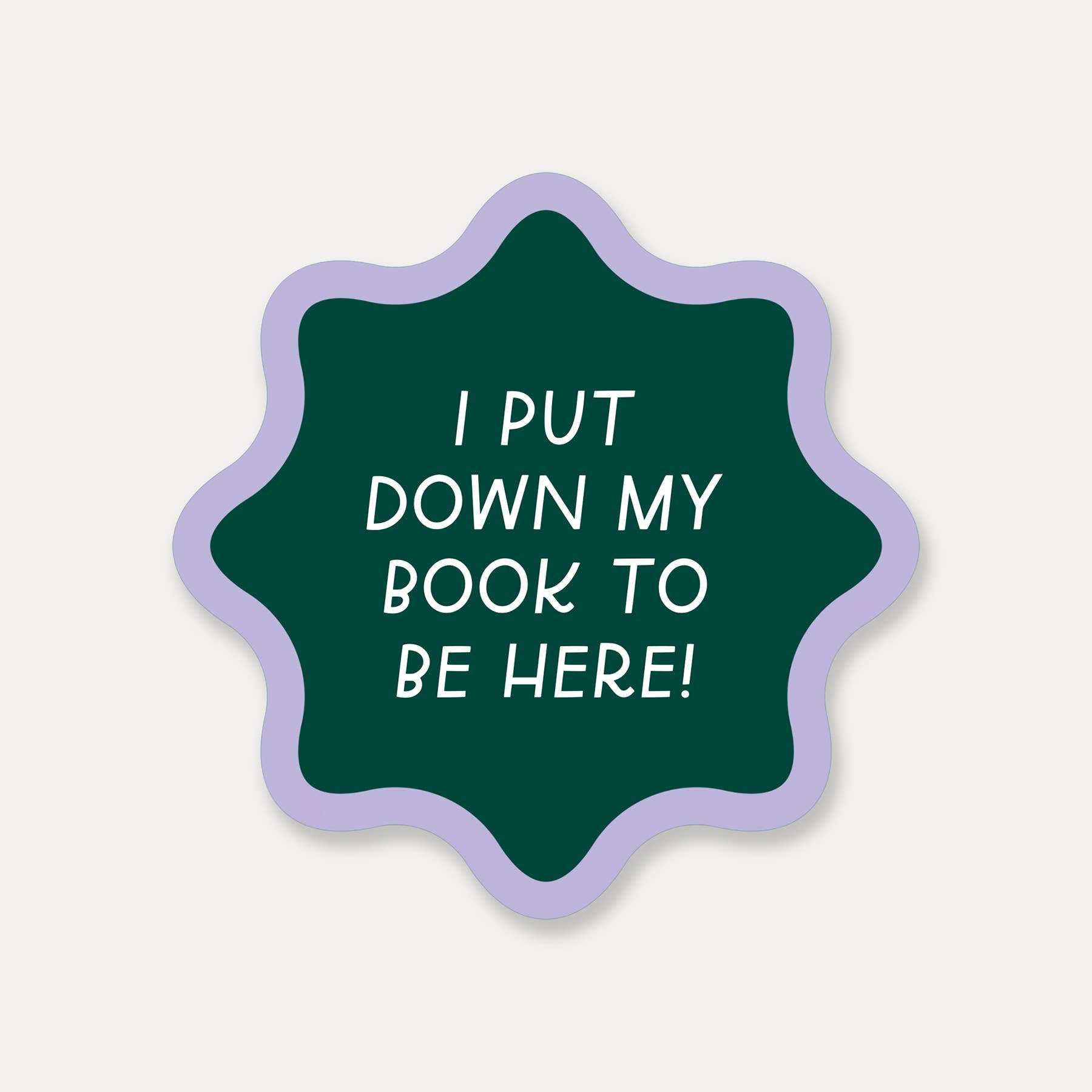 Green star-shaped sticker with white text on a light gray background