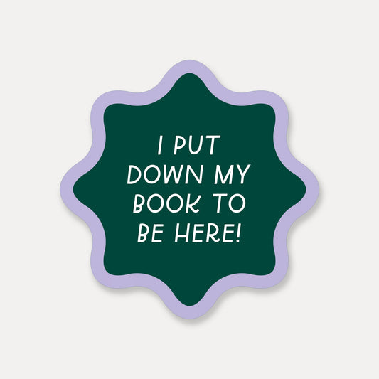 Green star-shaped sticker with white text on a light gray background
