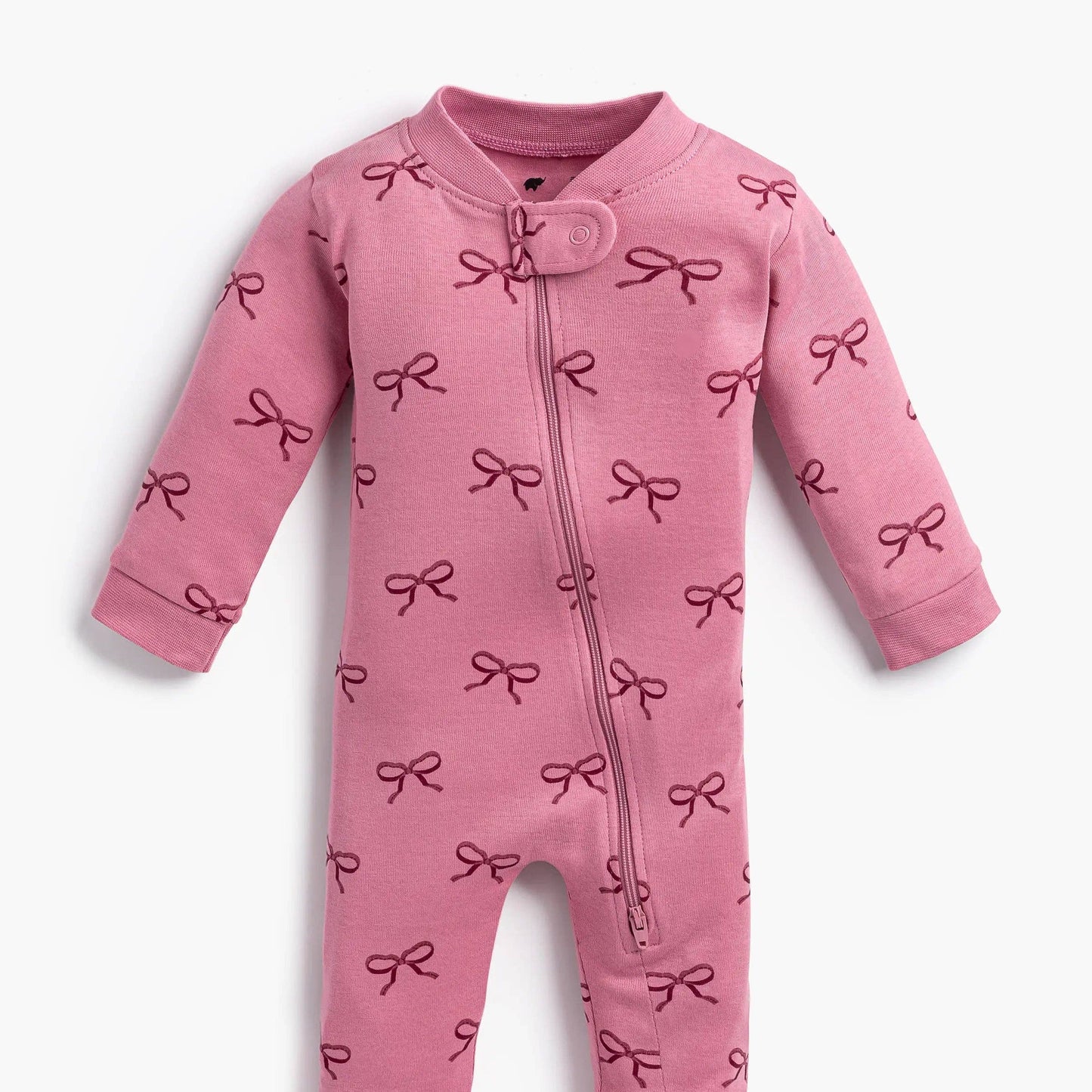 Pink baby onesie with bow pattern on a white background