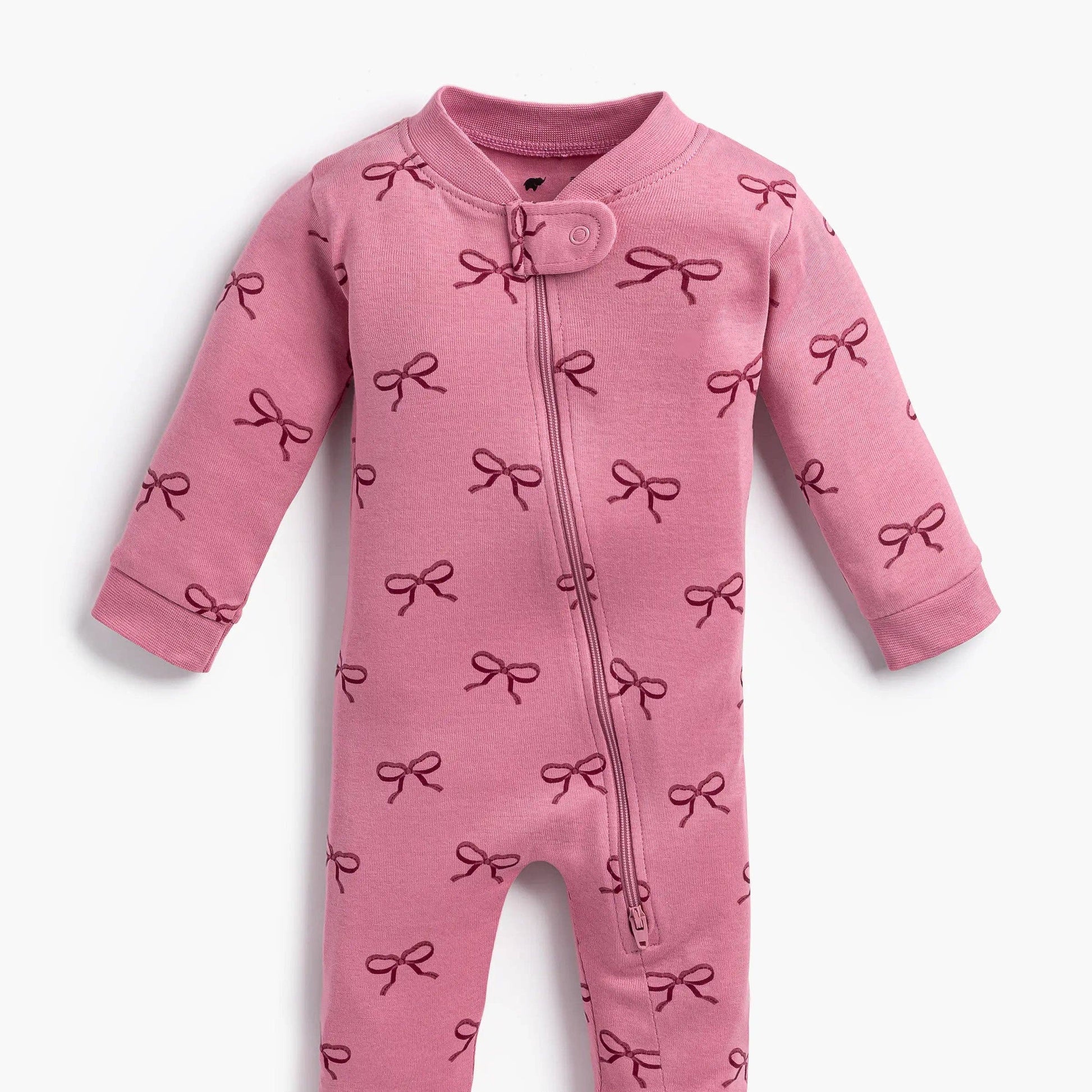 Pink baby onesie with bow pattern on a white background