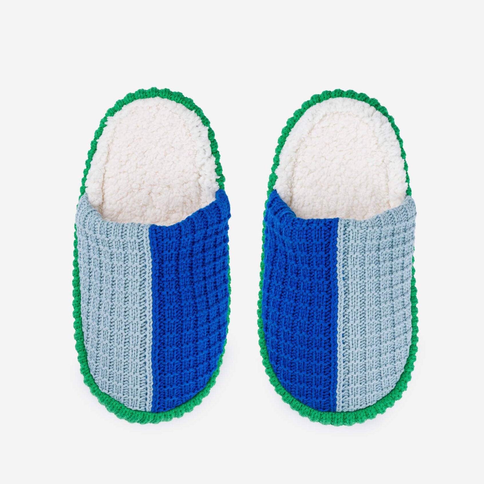 Pair of blue and gray slippers with green trim on a white background