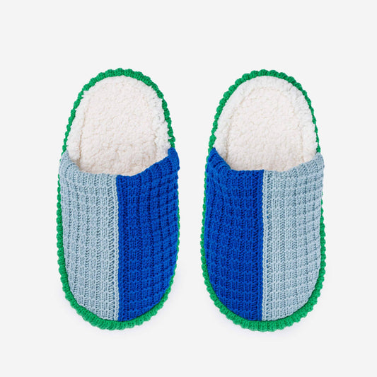 Pair of blue and gray slippers with green trim on a white background