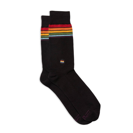 Black sock with rainbow striped pattern on a white background