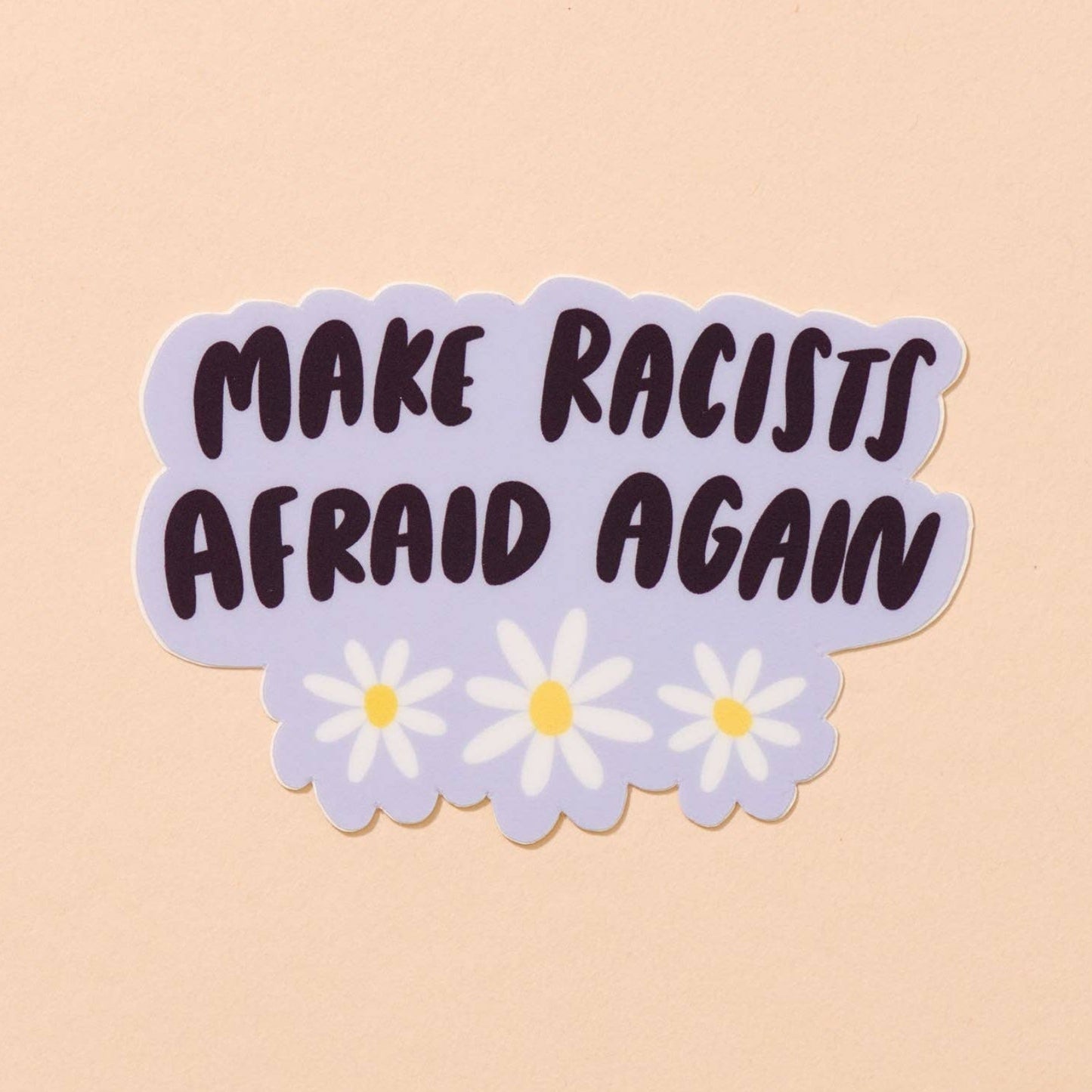Sticker with 'MAKE RACISTS AFRAID AGAIN' text on a beige background