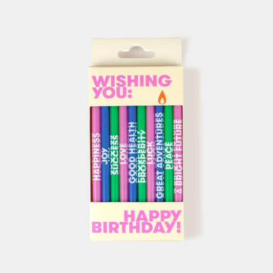Pack of colorful birthday candles with text on a white background