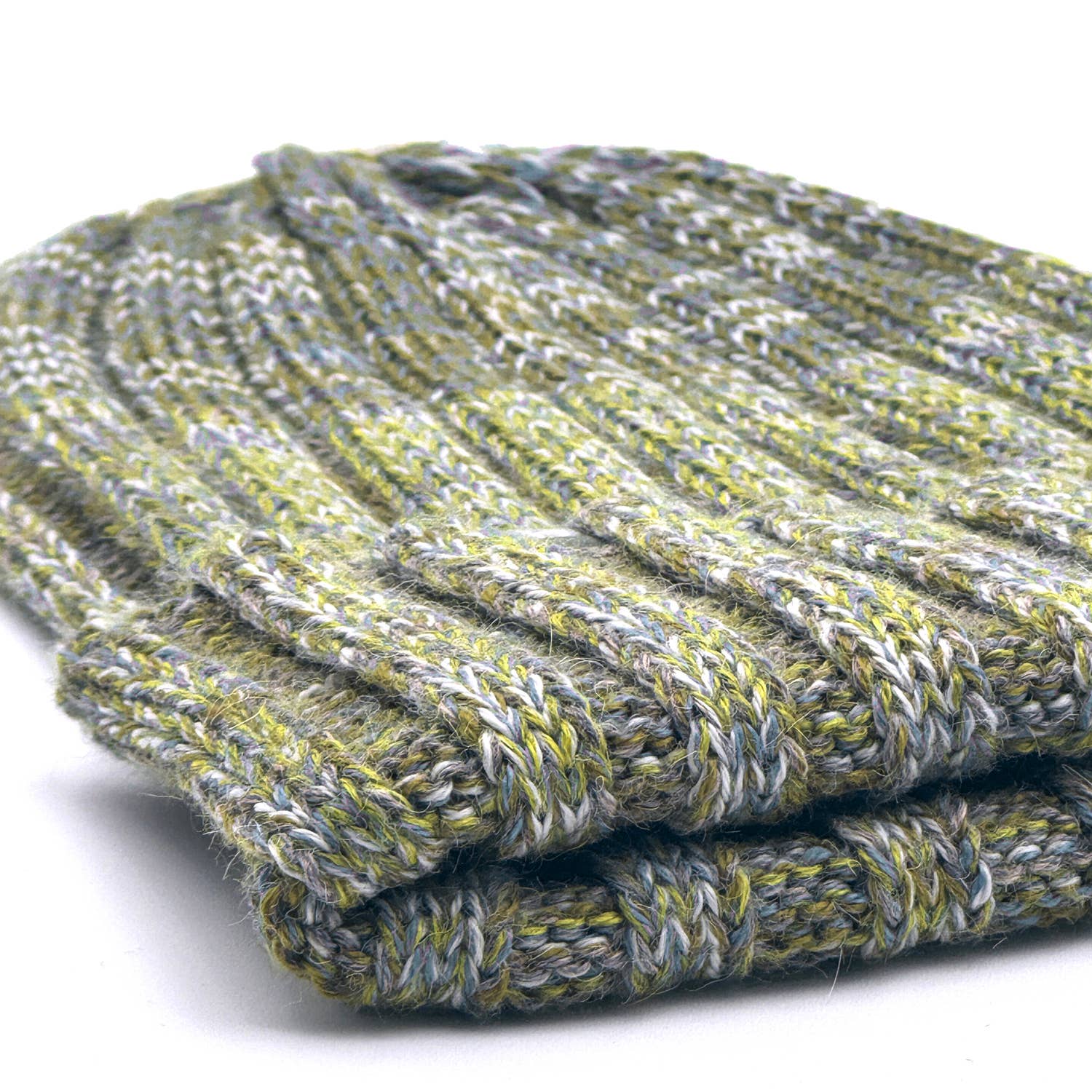 Folded green and gray textured fabric on a white background