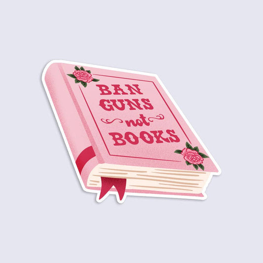 Pink book-shaped sticker with 'Ban Guns not Books' text on a light gray background