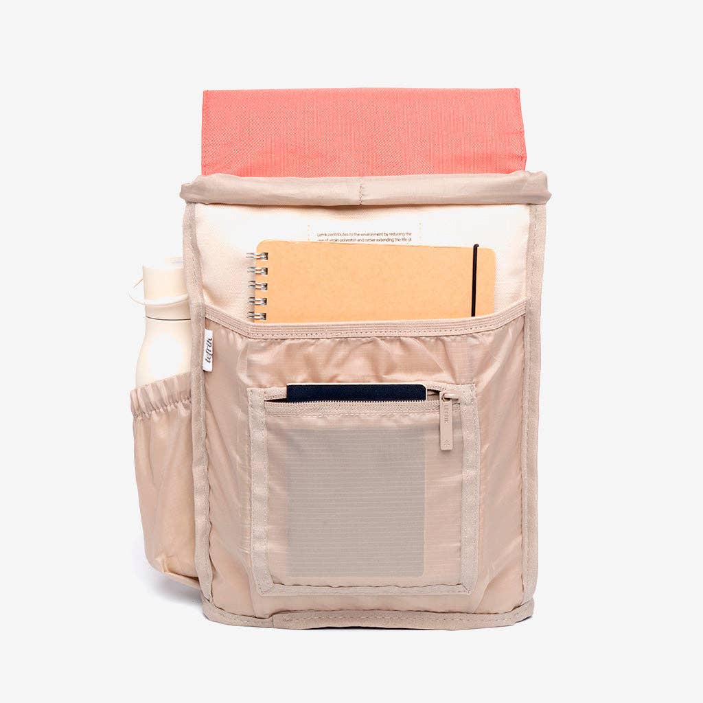A color-blocked canvas backpack with a coral pink top flap and handle1