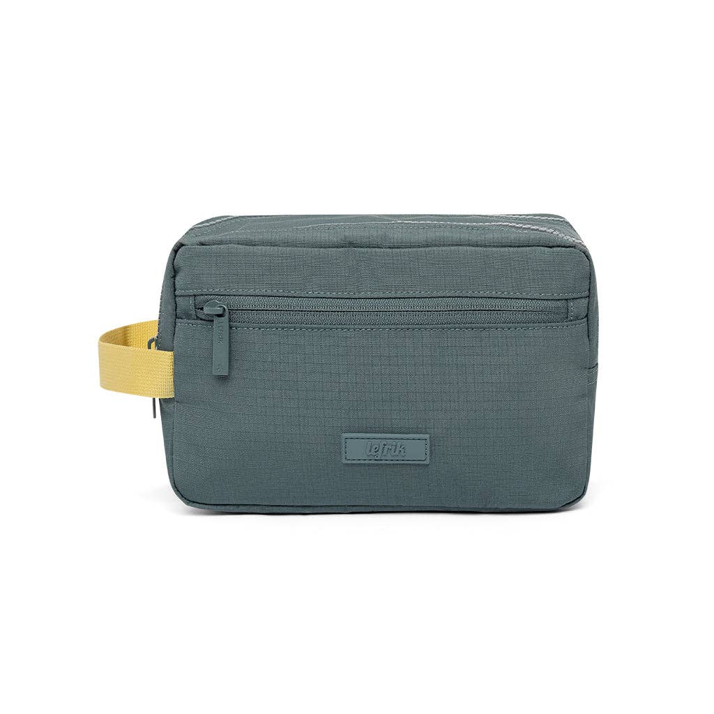 A dark slate blue-gray zippered pouch bag with a yellow strap and a small gray brand patch on the front, shown against a plain white background